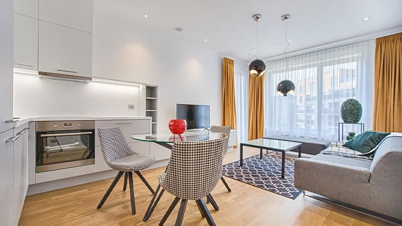 Living room with glass table and aluminium-framed openings